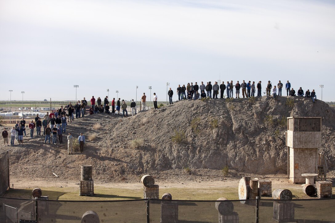 Marine Attack Squadron 211 Marines sit on top of a hill above the Marine Corps Air Station Yuma paintball field and watch as teams battle head-to-head to see the who will be top dog, Feb 15.