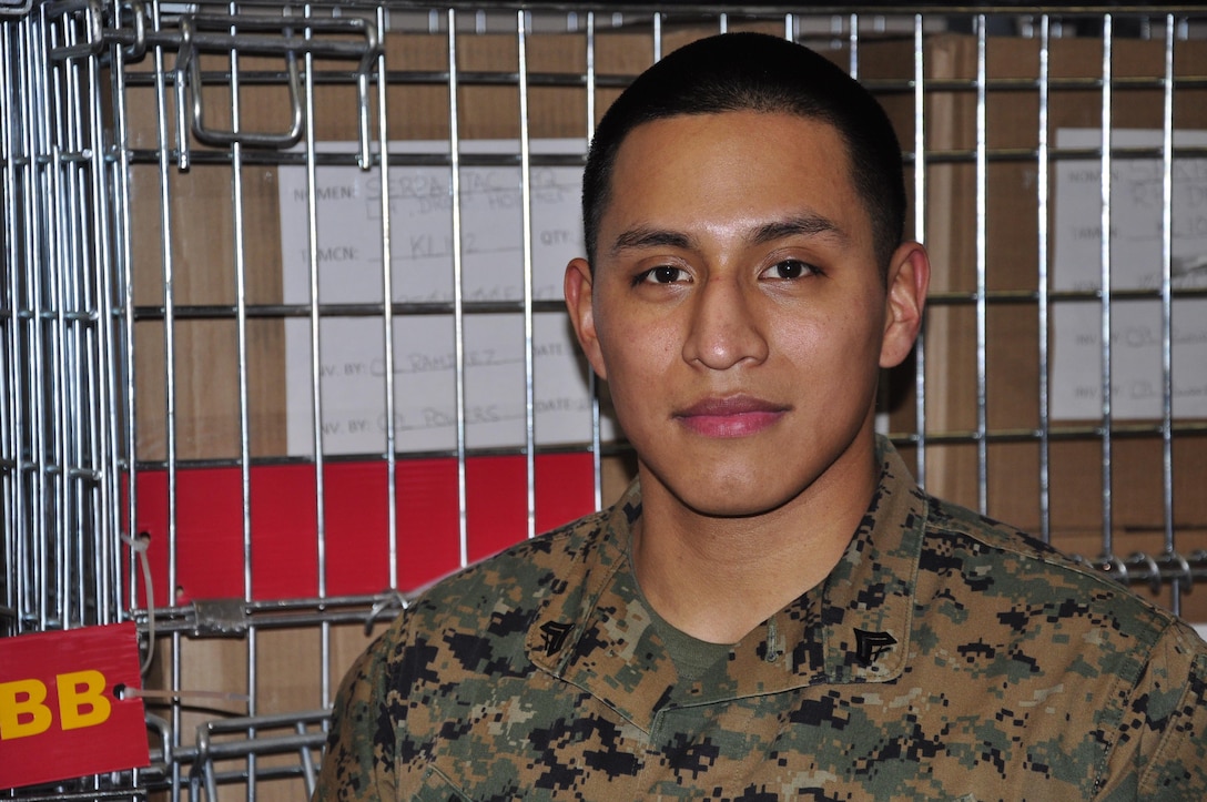 Cpl. Michael Ramirez, Headquarters and Service Battalion's Noncommissioned Officer of the 4th Quarter and Noncommissioned Officer of the Year, stands in front of one of the bins in Security Battalion's warehouse. Ramirez is currently the Security Bn. warehouse chief.