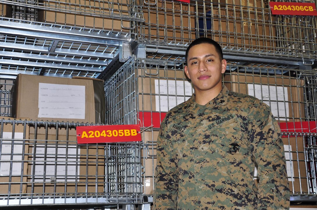 Cpl. Michael Ramirez, Headquarters and Service Battalion's Noncommissioned Officer of the 4th Quarter and Noncommissioned Officer of the Year, stands in front of one of the bins in Security Battalion's warehouse. Ramirez is currently the Security Bn. warehouse chief.
