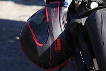A motorcycle helmet hangs from a motorcycle during a 2nd Maintenance Battalion, Combat Logistics Regiment 25, 2nd Marine Logistics Group quarterly motorcycle rally and safety brief aboard Camp Lejeune, N.C., Feb. 15, 2013. Motorcycle riders from the battalion gathered to review safety procedures before taking their bikes out for a ride.