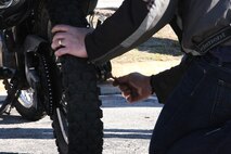 A Marine with 2nd Maintenance Battalion, Combat Logistics Regiment 25, 2nd Marines Logistics Group performs maintenance on his motorcycle at a rally and safety brief for the battalion’s riders aboard Camp Lejeune, N.C., Feb. 15, 2013. Every rider is required to take a motorcycle riding class to ensure they are prepared to operate their vehicles safely.