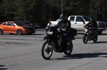 Marines with 2nd Maintenance Battalion, 2nd Marine Logistics Group ride through a parking lot aboard Camp Lejeune, N.C., Feb. 15, 2013. The servicemembers gathered for their quarterly safety brief and motorcycle rally, which helps the battalion ensure its Marines remain informed of Marine Corps motorcycle regulations and safety standards. 