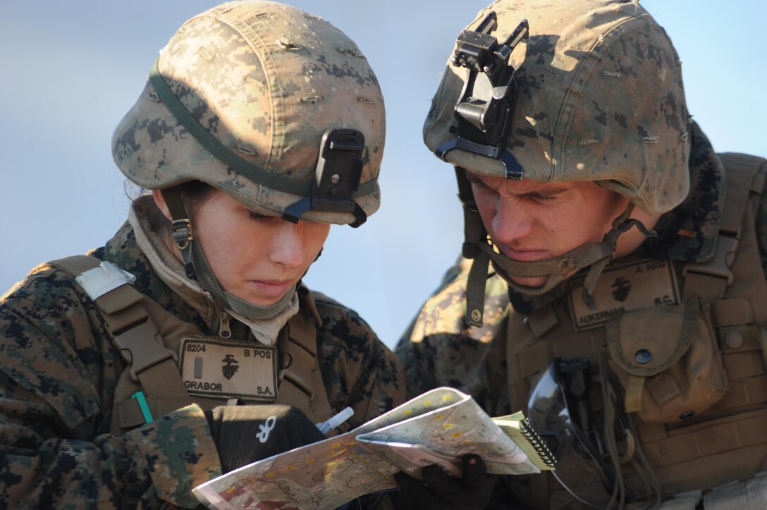 2nd Lt. Stephanie Grabor, and 2nd Lt. Ryan Aukerman, students, Alpha Co., The Basic School, study a map before calling for 155mm artillery fire support during a call for fire exercise.
