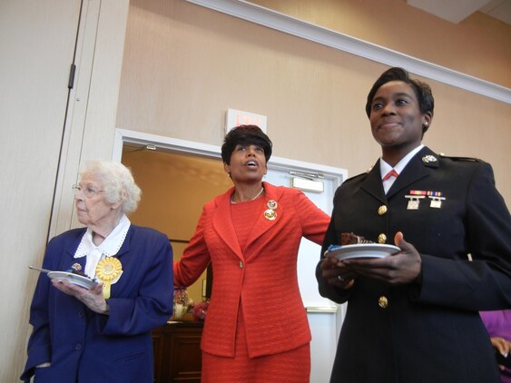 Iona Gilbert, left, of the D.C. chapter of the Women Marines Association, was the first of the attendees at the Feb. 16 anniversary celebration to join the Corps, enlisting in 1943, and Lt. Tracey Fetherson, right, was the latest. As such, WMA National President Betty Moseley-Brown, presented them with the first pieces of cake. 