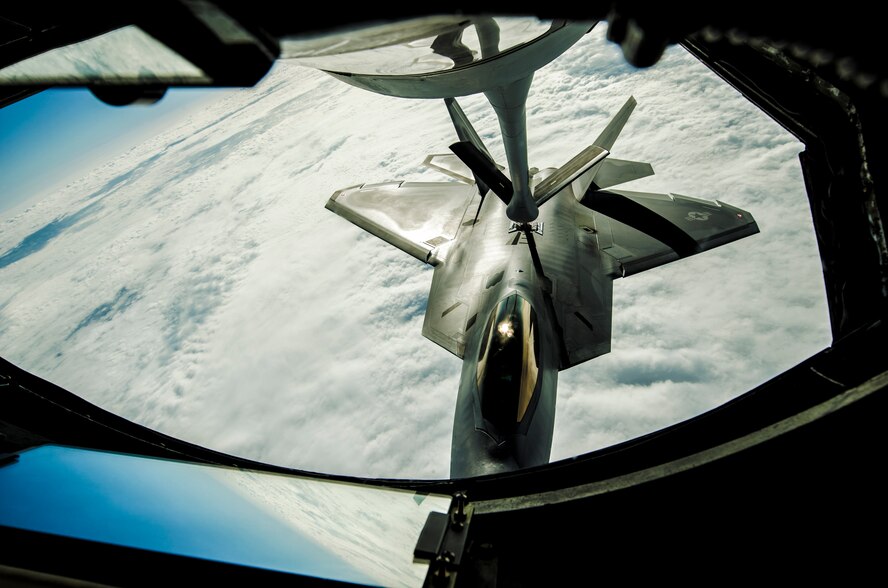 A KC-135 Stratotanker refueling aircraft refuels an F-22 Raptor fighter aircraft during a training sortie near Kadena Air Base, Japan, Feb. 19, 2013. Raptors from Joint Base Langley-Eustis, Va., are deployed to Kadena to promote stability and security in the pacific region. (U.S. Air Force Photo/Airman 1st Class Tyler Prince.)