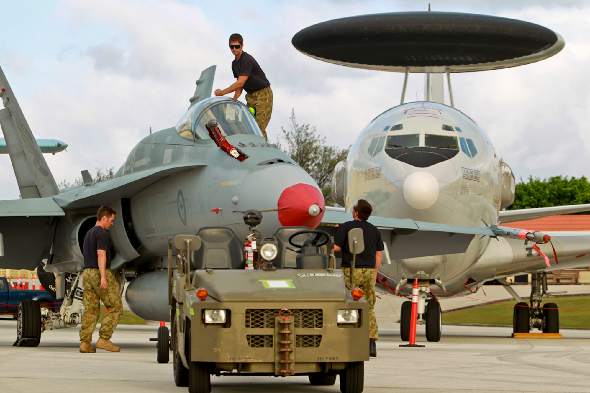 Australian airmen guide a Royal Australian Air Force F/A-18 Hornet aircraft into position Feb. 1, 2013, at Andersen Air Force Base, Guam, in preparation for a photo shoot during exercise Cope North 2013. Cope North is an annual air combat tactics, humanitarian assistance and disaster relief exercise designed to increase the readiness and interoperability of the U.S. Air Force, Japan Air Self-Defense Force and RAAF. (DoD photo by Leading Aircraftman Craig Barrett, Royal Australian Air Force)