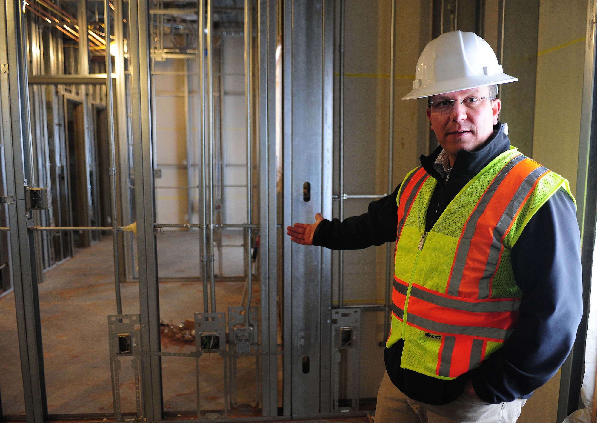 Robert Ferry, 27th Special Operations Civil Engineer Squadron chief of unaccompanied housing, gives a tour of the new dorms currently under construction at Cannon Air Force Base, N.M., Feb. 20, 2013. The 96-person dorms have been under construction since August of 2012 and one is expected to be completed later this year. (U.S. Air Force photo/Airman 1st Class Ericka Engblom)