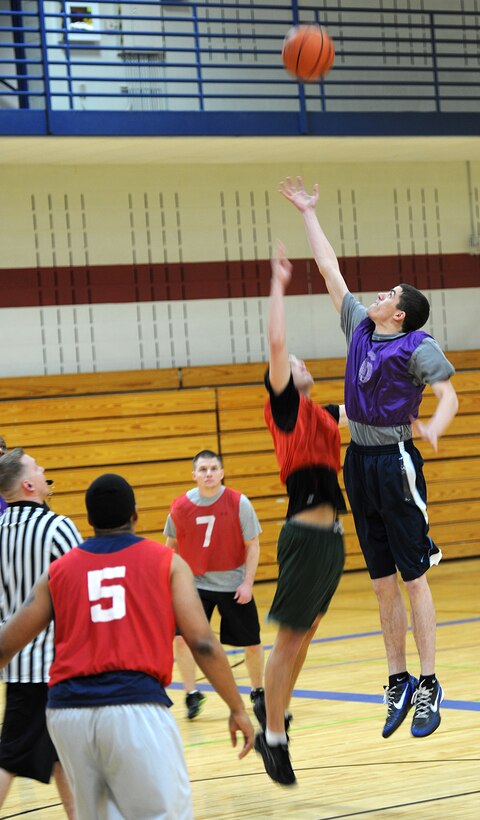 Airman 1st Class Joshua Jordan, 28th Logistics Readiness Squadron fuels distribution operator, jumps to gain control of the ball during the base 2013 Intramural Basketball League tournament in the Bellamy Fitness Center at Ellsworth Air Force Base, S.D., Feb. 19, 2013. The 28th LRS squared off against the 28th Force Support Squadron, and won, 40-33. (U.S. Air Force photo by Airman 1st Class Hrair H. Palyan/Released)