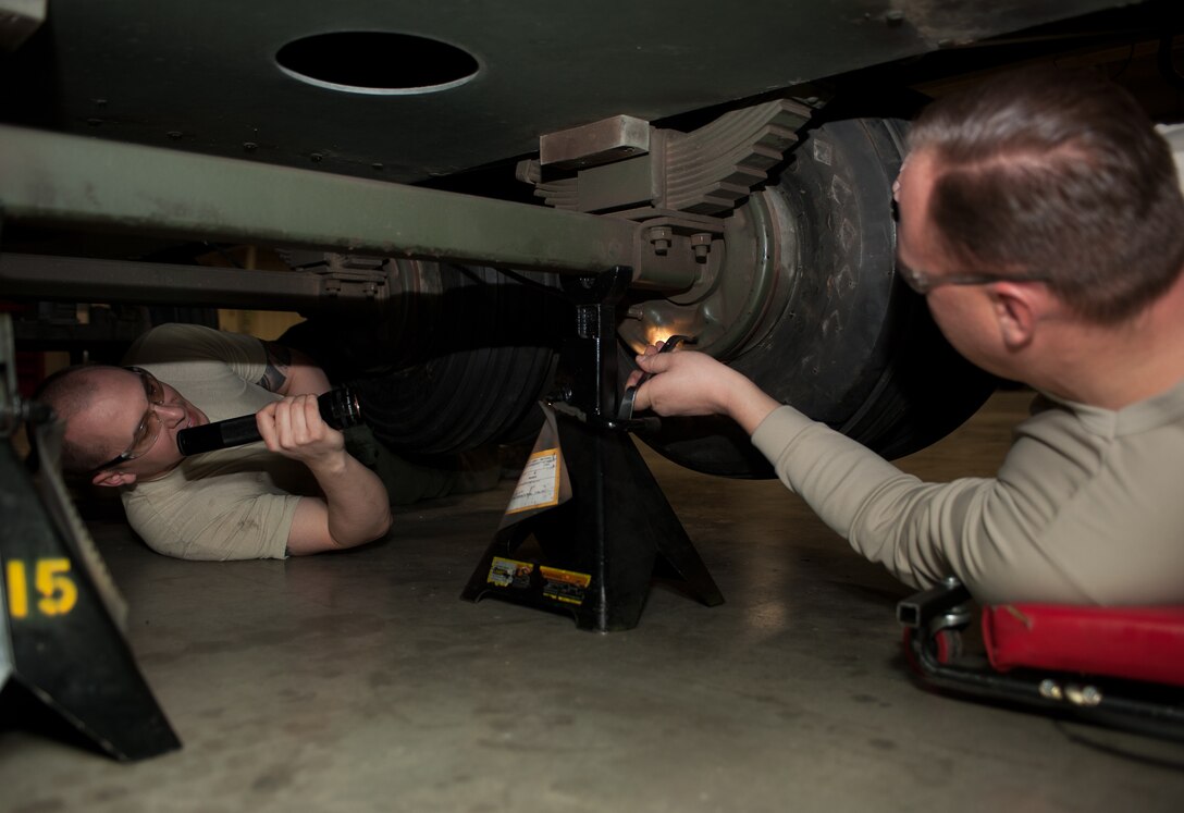Tech. Sgt Robert Holyoke (left), 28th Munitions Squadron support equipment technician, and Tech. Sgt Christopher Shields, 28th Munitions Squadron trailer maintenance NCO in charge, adjust brake pads on a munitions trailer during a brake bleeding process at Ellsworth Air Force Base, S.D., Feb. 7, 2013. The 28th MUNS is responsible for the maintenance and upkeep of more than 175 munitions trailers on base. (U.S. Air Force photo by Airman 1st Class Alystria Maurer/Released)