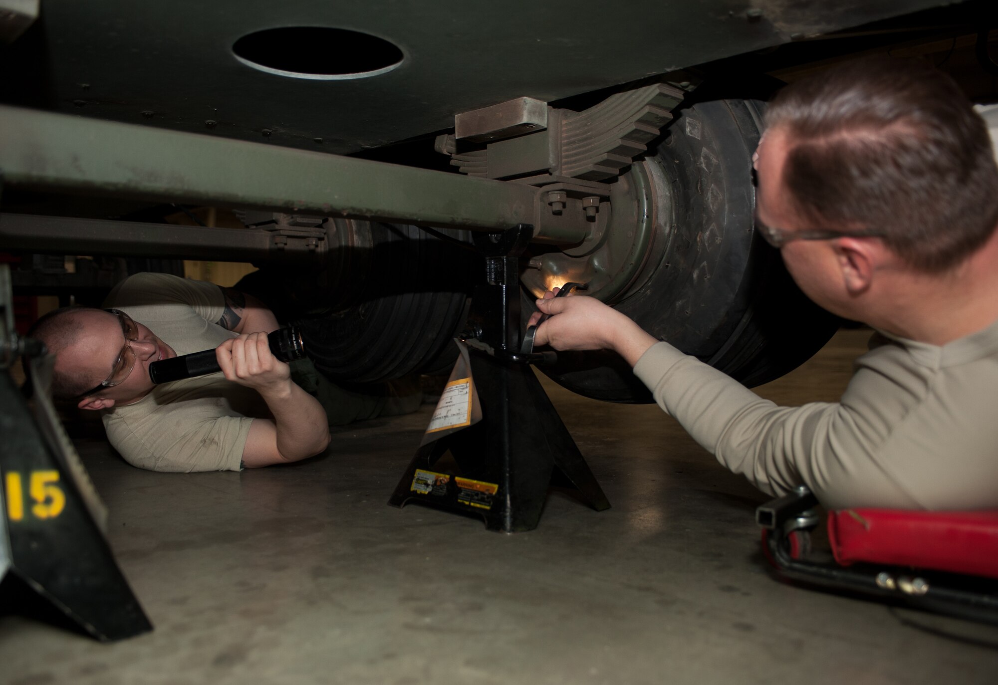 Tech. Sgt Robert Holyoke (left), 28th Munitions Squadron support equipment technician, and Tech. Sgt Christopher Shields, 28th Munitions Squadron trailer maintenance NCO in charge, adjust brake pads on a munitions trailer during a brake bleeding process at Ellsworth Air Force Base, S.D., Feb. 7, 2013. The 28th MUNS is responsible for the maintenance and upkeep of more than 175 munitions trailers on base. (U.S. Air Force photo by Airman 1st Class Alystria Maurer/Released)