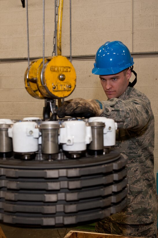 Senior Airman Ian McHaley, 28th Maintenance Squadron hydraulics technician, maneuvers a B-1 brake into a crate prior to shipping it on Ellsworth Air Force Base, S.D., Feb. 15, 2013. Hydraulics technicians are responsible for maintaining all hydraulic systems components on the base’s fleet of B-1 bombers. (U.S. Air Force photo by Airman 1st Class Kate Thornton-Maurer/Released)
