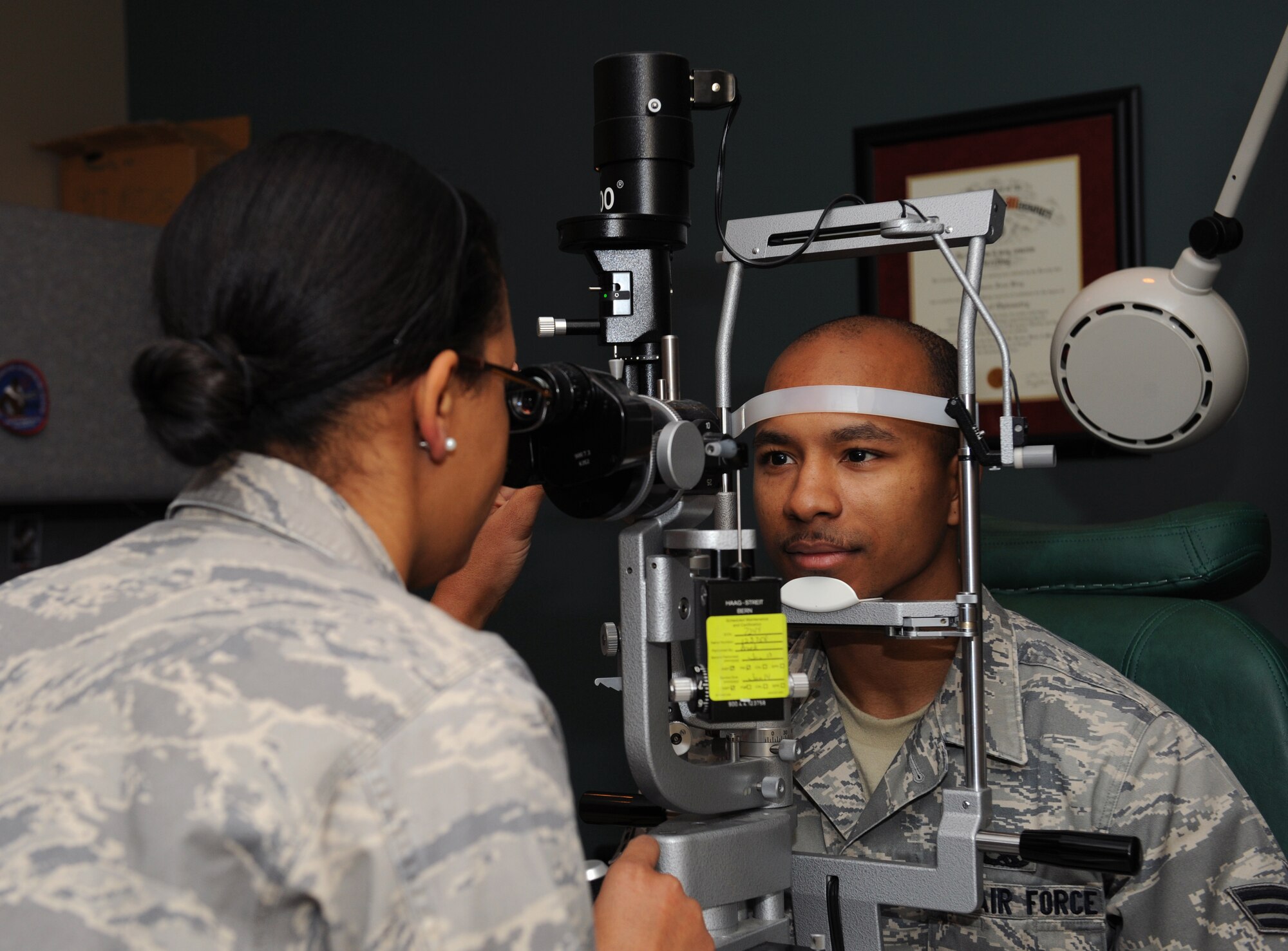 Senior Airman Deven Sherk, 2nd Maintenance Squadron phase support, receives an eye exam from Maj. Stephanie King, 2nd Aerospace Medicine Squadron optometrist, at the Optometry Clinic on Barksdale Air Force Base, La., Feb. 20. A big microscope, called a slit lamp, is used to check the health of patient's eyes during an examination. (U.S. Air Force photo/Airman 1st Class Benjamin Gonsier)
