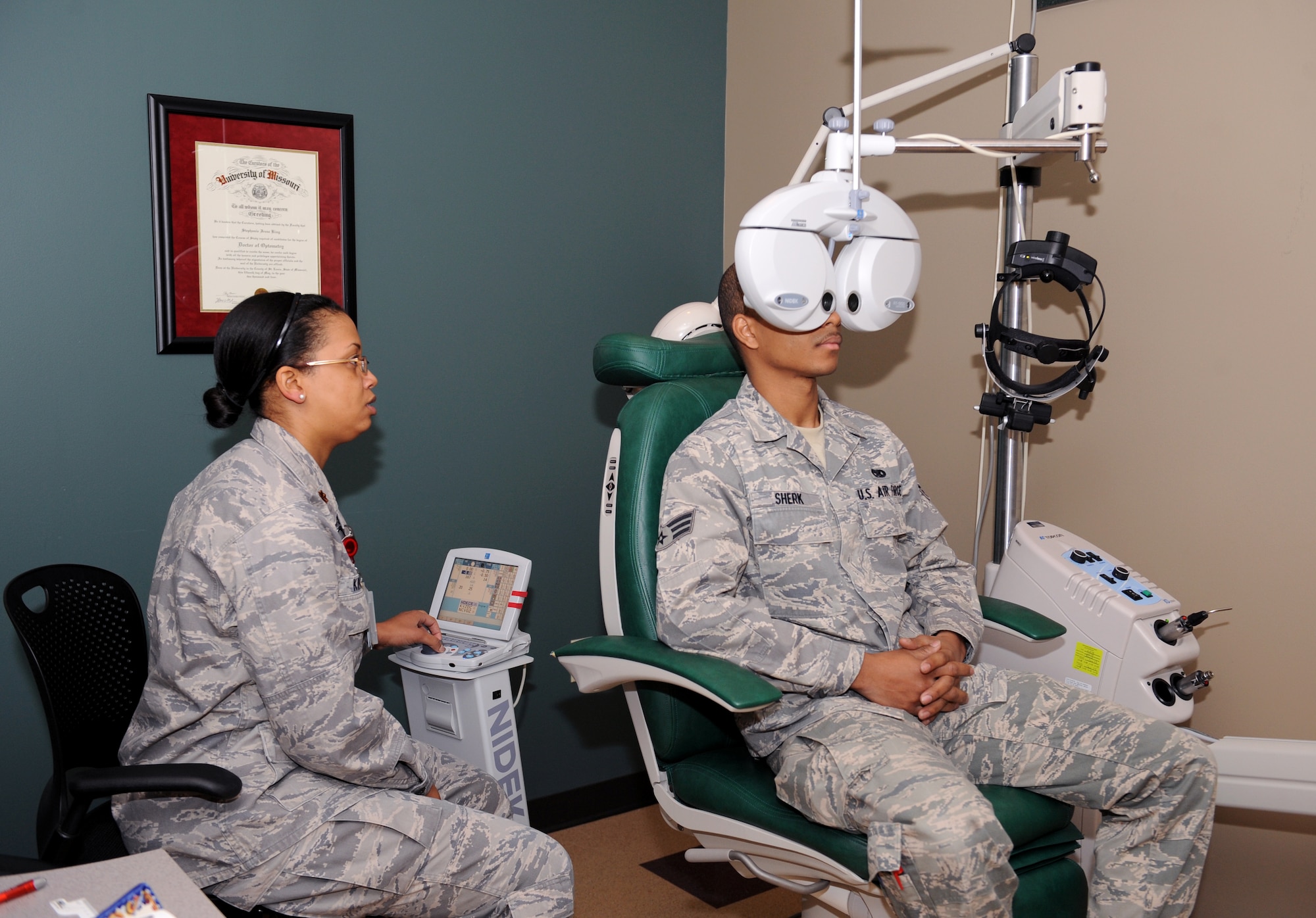 Maj. Stephanie King, 2nd Aerospace Medicine Squadron optometrist, switches lenses on a phoropter during a sight examination at the Optometry Clinic on Barksdale Air Force Base, La., Feb. 20. The phoropter contains different lenses for each eye, which helps the optometrist find the correct prescription for the patient. (U.S. Air Force photo/Airman 1st Class Benjamin Gonsier)
