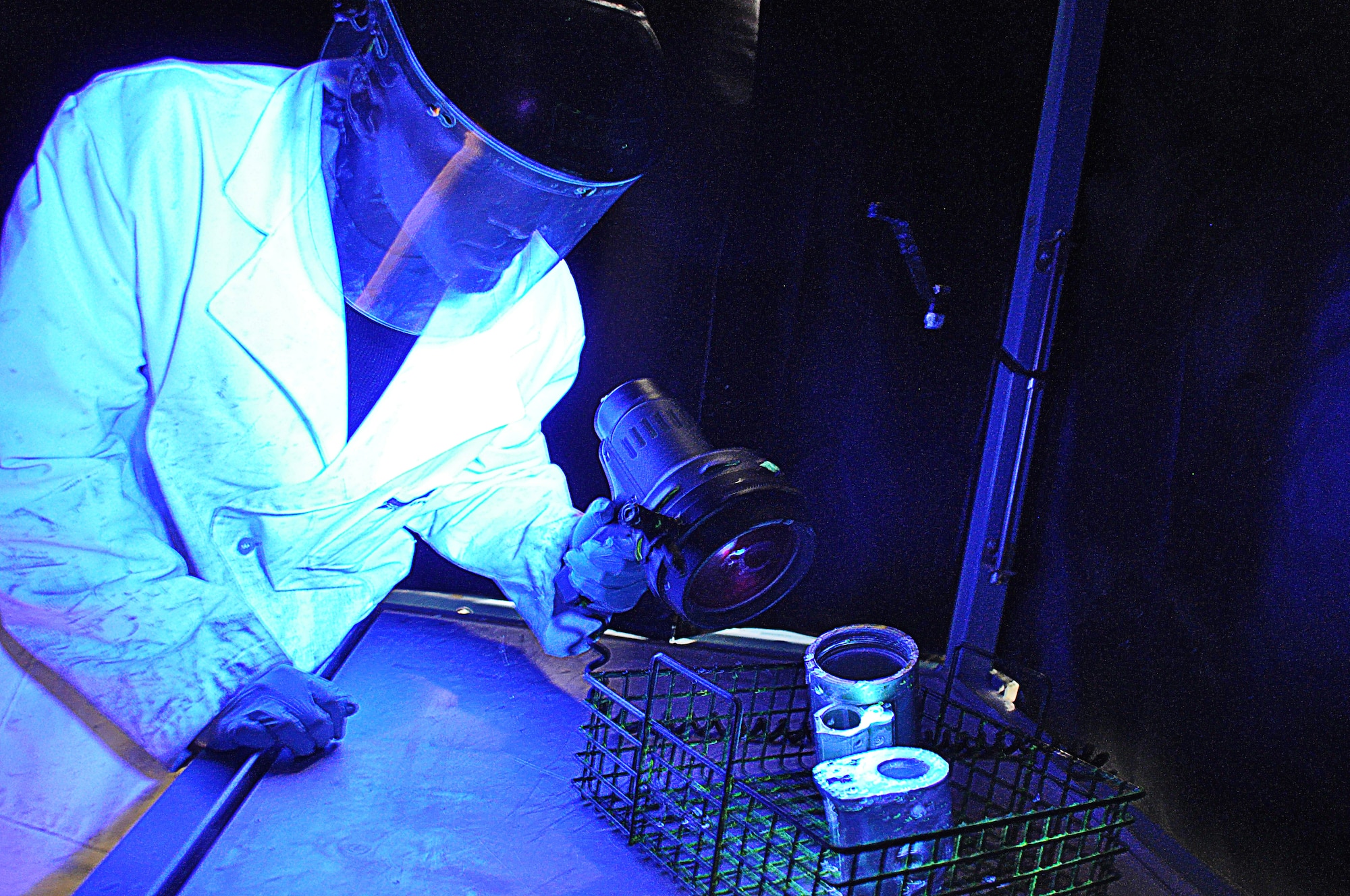 Tech. Sgt. Steven Smith, 507th Air Refueling Wing non-destructive inspection lab shop chief inspects parts off a KC-135 Stratotanker during the final stage of a penetrant test.  The black light shows any cracks that are not visible to the human eye.  The NDI lab inspects about 300 parts either in the lab or with their portable units every month.  (U.S. Air Force photo by Senior Airman Mark Hybers)