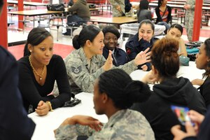 U.S. Air Force Staff Sgt.'s Koreta Gabriel and LaTonya King, both 633rd Security Forces Squadron members, speak with Air Force Reserve Officers' Training Corps cadets during Hampton High School's Women in the Military forum at Hampton High School, Feb. 13, 2013. At the event, the Airmen spoke with students about military careers and knowledge. (U.S. Air Force photo by Staff Sgt. Ciara Wymbs/Released)
