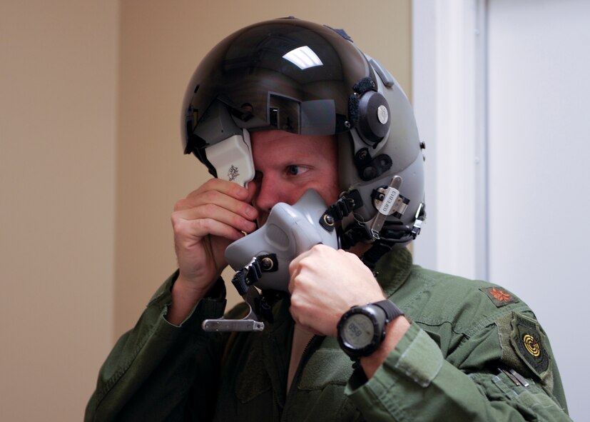 U.S. Air Force Maj. Gage Evert, 74th Fighter Squadron A-10C Thunderbolt II pilot , places a protective clip on the monocle of the Helmet Mounted Cueing System (HMCS) at Moody Air Force Base, Ga., Jan. 17, 2013. Airmen with the 23d Operations Support Squadron are being trained  by GENTEX® Corporations technical specialists to individually fit and maintain the HMCS for the 74th FS pilots. (U.S. Air Force photo by Senior Airman Eileen Meier/Released)