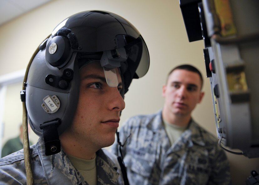 U.S. Air Force Airman 1st Class Sean Crowell and Senior Airman David Hainley, 23d Operations Support Squadron aircrew flight equipment technicians, administer a preflight test for the Helmet Mounted Cueing System (HMCS) at Moody Air Force Base, Ga., Jan. 17, 2013. Airmen with the 74th Fighter Squadron are the first to field the HMCS for the A-10C Thunderbolt II at Moody and downrange. (U.S. Air Force photo by Senior Airman Eileen Meier/Released)