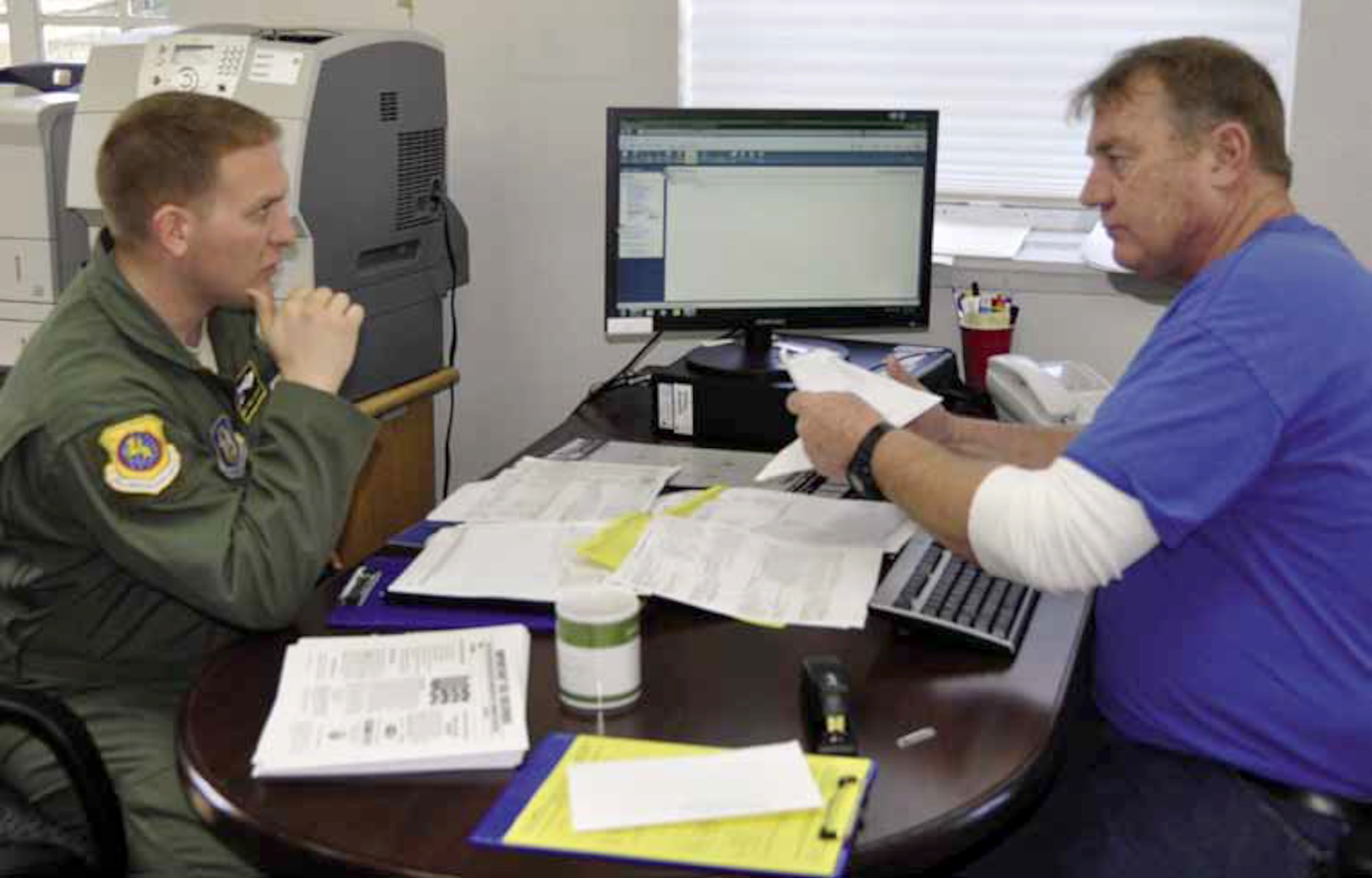 Master Sgt. Chris Schuldes (left), 452d Airlift Control Flight, is seated with Gabriel Verhage, director, Volunteer Income Tax Assistance center, discussing matters involving his 2012 federal and state tax returns, Feb. 14 — this will be the second year in a row that Schuldes has utilized this service. The tax center will process and E-file returns for all March members on appointment or walk-in basis, free of charge. (U.S. Air Force photo by Darnell Gardner)