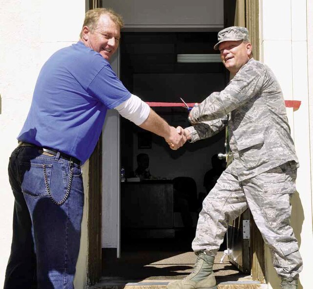 Col. Samuel Mahaney (right), commander, 452d Air Mobility Wing, officially opened the Volunteer Income Tax Assistance center after the ceremonial ribbon-cutting and handshake with the director of the VITA center, Gabriel Verhage, Feb. 14. The tax center will process and E-file all March members’ federal and state returns, free of charge. (U.S. Air Force photo by Darnell Gardner)