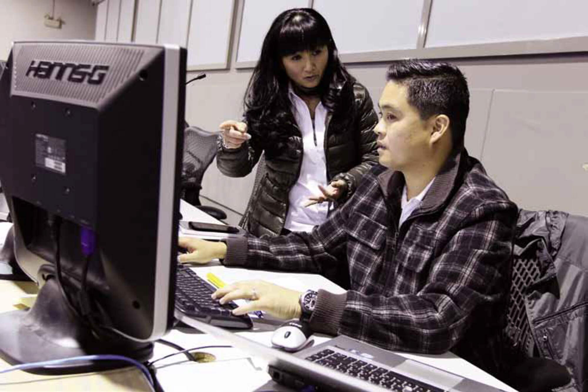 Hong Nguyen, left, head of the Missile Defense Branch and Remar Balatero, event lead for Flight Test Mission 20, discuss preparations for an Aegis Ballistic Missile Defense System test at Naval Surface Warfare Center, Corona Division. The FTM-20 demonstrated for the first time, the system’s capability to detect a target from outer space and launch a sea-based Standard Missile from an Aegis-equipped Navy ship to destroy a medium-range ballistic missile. The event was conducted with tracking data from satellite sensors orbiting the Earth. (U.S. Navy photo by Troy Clarke)