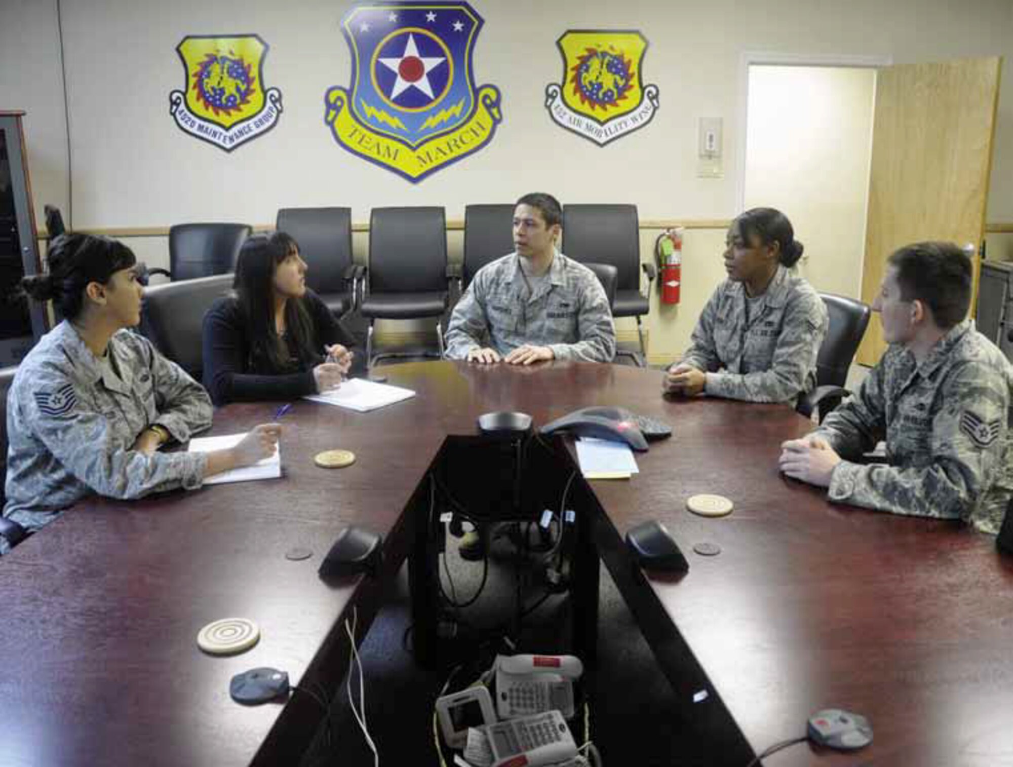 Members of the 452d Maintenance Operations Squadron Rising Six gather to discuss items concerning upcoming squadron activities. Seated from the left are Tech. Sgt. Araceli Saucedo, Senior Airmen Elizabeth Silva, Staff Sgt. James Marquez, Senior Airman Ruth Every and Staff Sgt. Robert Rurup. (U.S. Air Force photo by Darnell Gardner)