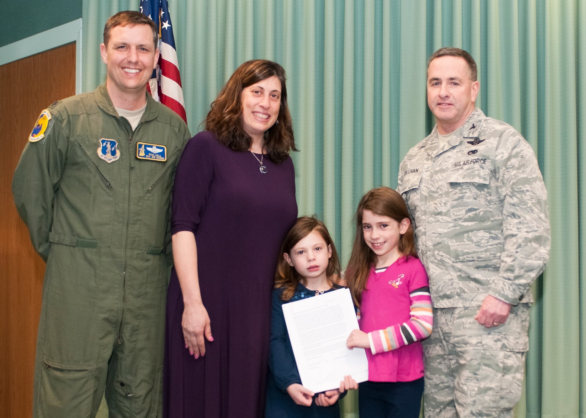 Lt. Col. Paul Kell (left), Loren Selig, Gabi Selig, Zoe Selig, and Col. Peter Sullivan pose for a  photo after a ceremony where Zoe read and presented Sullivan with a letter of support for Pease Air National Guard Base to receive the new Boeing KC-46A air refueling tanker, Feb 20, 2013.  The letter was signed by 59 of the girls' friends at Moharimet Elementary School in Madbury, N.H. (National Guard photo by Tech. Sgt. Aaron Vezeau/Released)