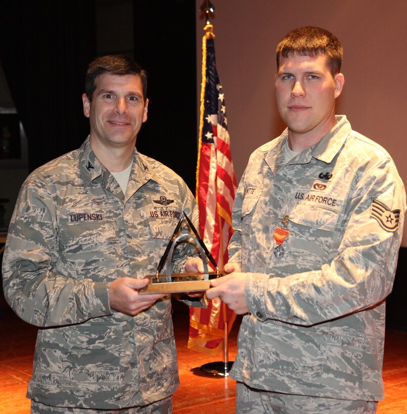 Col. Albert Lupenski, commander of the 932nd Airlift Wing, presents Staff Sgt. Blake Witte, the NCO of the Year award.  Blake and other annual award recipients were announced at wing commander's call on Feb. 10, 2013.  Blake is a explosive ordnance disposal specialist and is a member of the 932nd Civil Engineer Squadron.  (U.S. Air Force photo/Tech. Sgt. Christopher Parr) 