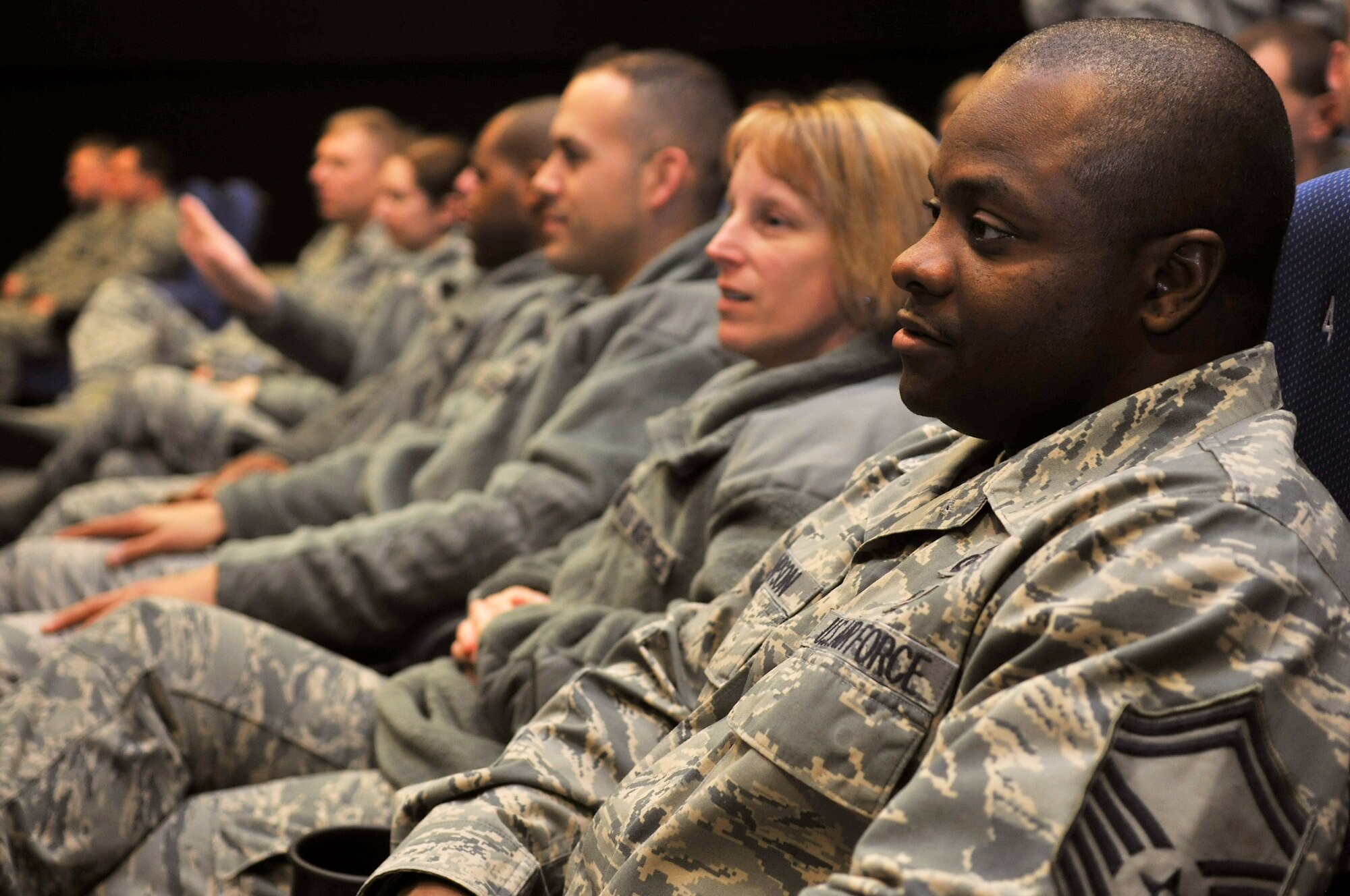 Team Mildenhall Airmen attend an enlisted all-call Feb. 21, 2013, at RAF Mildenhall, England. This was the first all-call for Chief Master Sgt. Tracy Jones since becoming the 100th Air Refueling Wing command chief. In addition to officially introducing himself to the Airmen, Jones spoke about his expectations and goals for the base's enlisted force. (U.S. Air Force photo by Senior Airman Jerilyn Quintanilla/Released) 