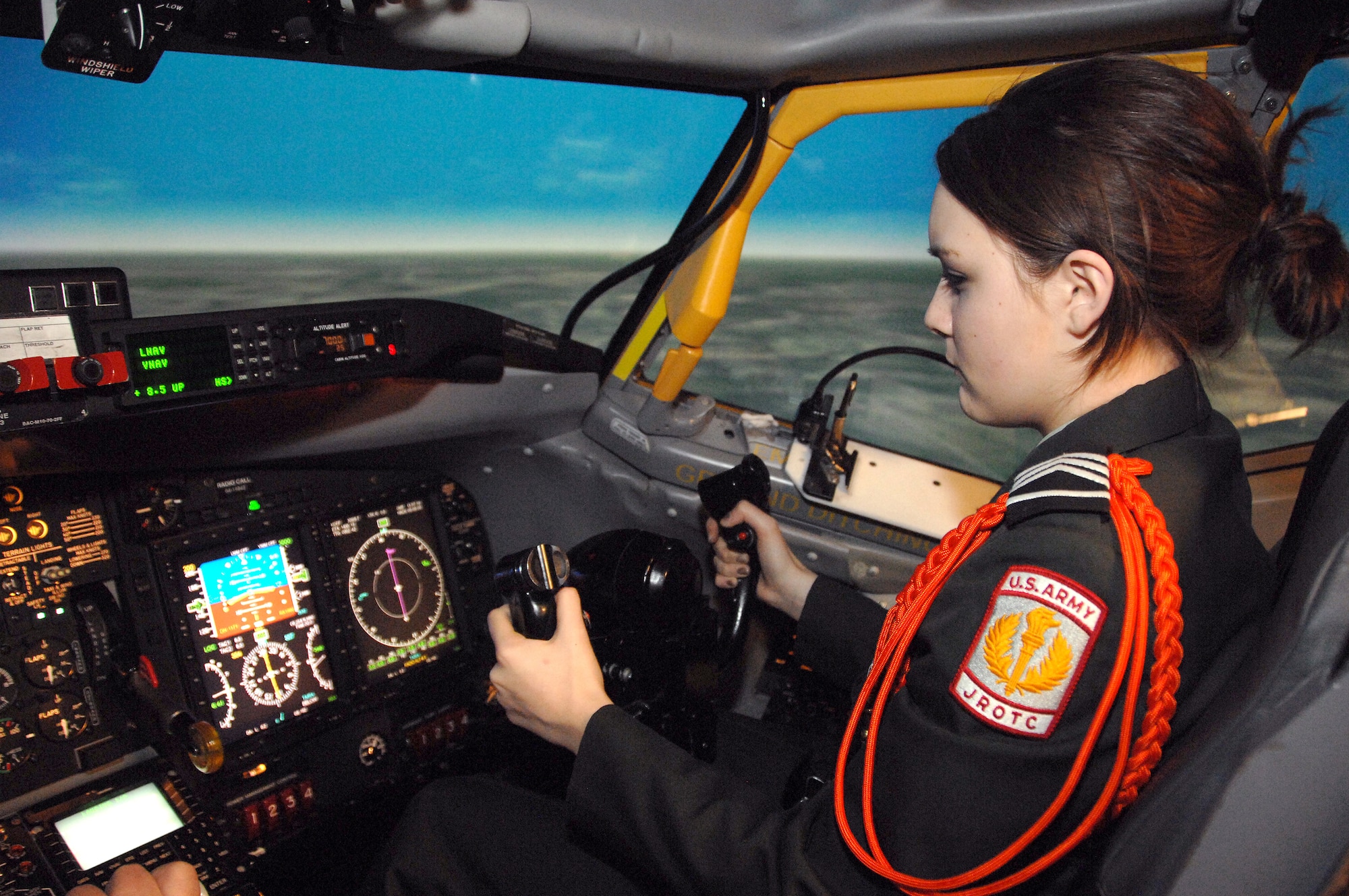 Omaha Benson High School JROTC cadet Tabitha Hanzlik controls an RC-135V/W Rivet Joint from the co-pilot seat inside a simulator at Offutt Air Force Base, Neb., Feb. 14. Hanzlik attempted takeoffs, landings and aerial refueling in the simulator. (U.S. Air Force photo by Delanie Stafford/Released)