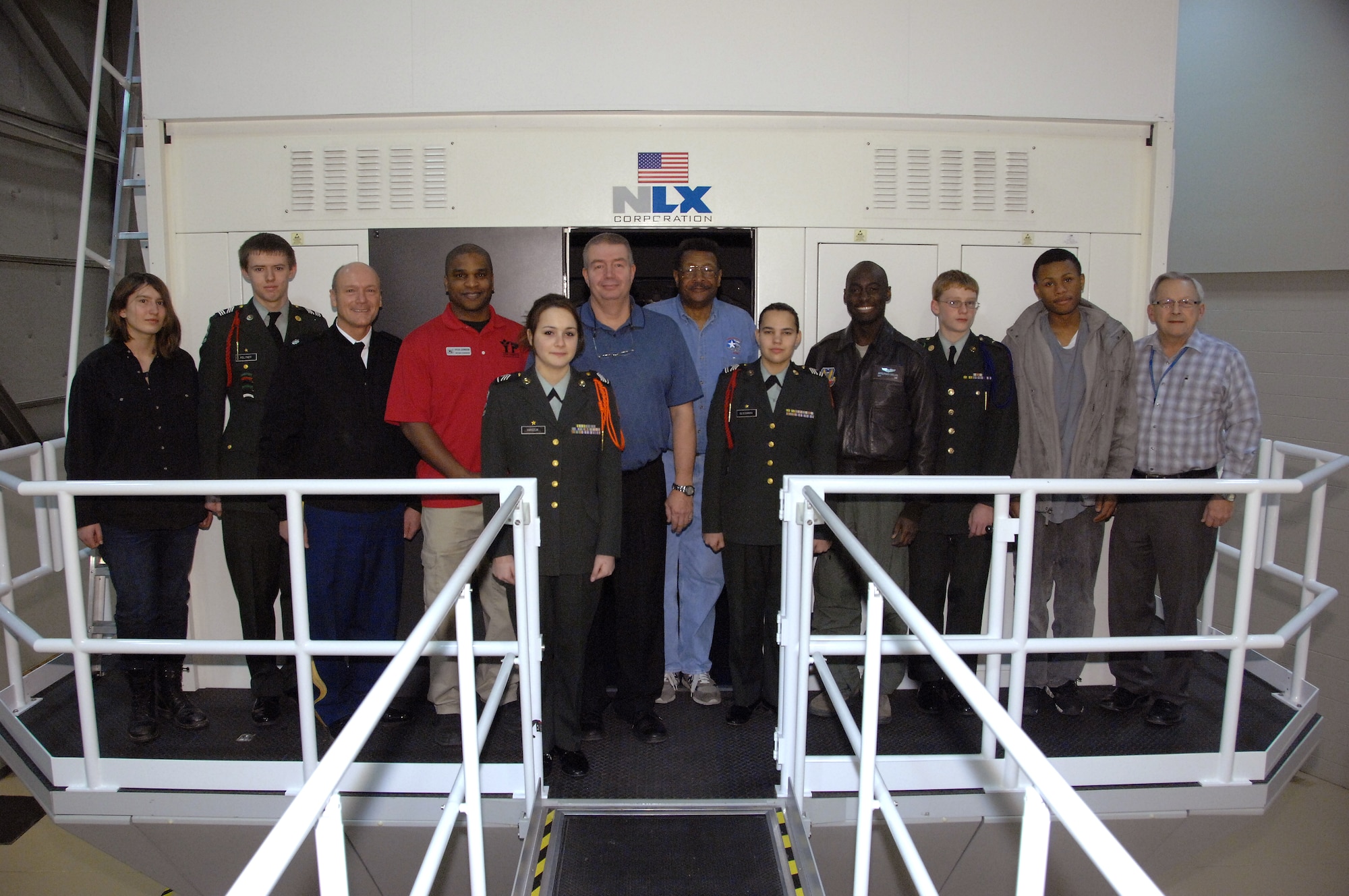 Omaha Benson High School JROTC cadets and volunteers from Offutt Air Force Base pose for a group shot outside of an RC-135V/W Rivet Joint simulator at Offutt AFB, Neb., Feb. 14. The cadets were participating in a program organized by the Alfonza W. Davis chapter of Tuskegee Airmen, Inc., designed to stimulate youth interest in science, technology, engineering and math. (U.S. Air Force photo by Delanie Stafford/Released)