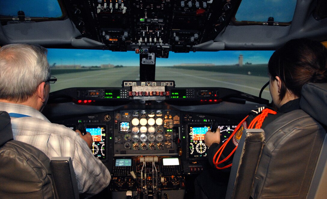 Omaha Benson High School JROTC cadet Tabitha Hanzlik, right, and Michael Cook, 338th Combat Training Squadron instructor pilot, prepare to takeoff inside an RC-135 simulator at Offutt Air Force Base, Neb., Feb. 14. Hanzlik was participating in a program organized by the Alfonza W. Davis chapter of Tuskegee Airmen, Inc., designed to stimulate youth interest in science, technology, engineering and math. (U.S. Air Force photo by Delanie Stafford/Released)
