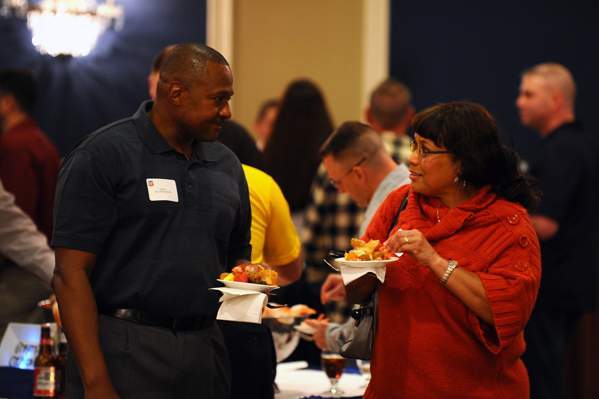 U.S. Air Force Chief Master Sergeants Arlandio Green (left) and Karen Harris (right) both from Joint Base Langley-Eustis socialize at the annual Air Combat Command Chief Master Sergeant’s mixer hosted at the Patriot Club Jan. 27 at Offutt Air Force Base, Neb.  Chief selects from across the command met at Offutt to begin a weeklong series of training and lectures to better prepare them for the highest enlisted rank in the U.S. Air Force.  (U.S. Air Force photo by Josh Plueger/Released)