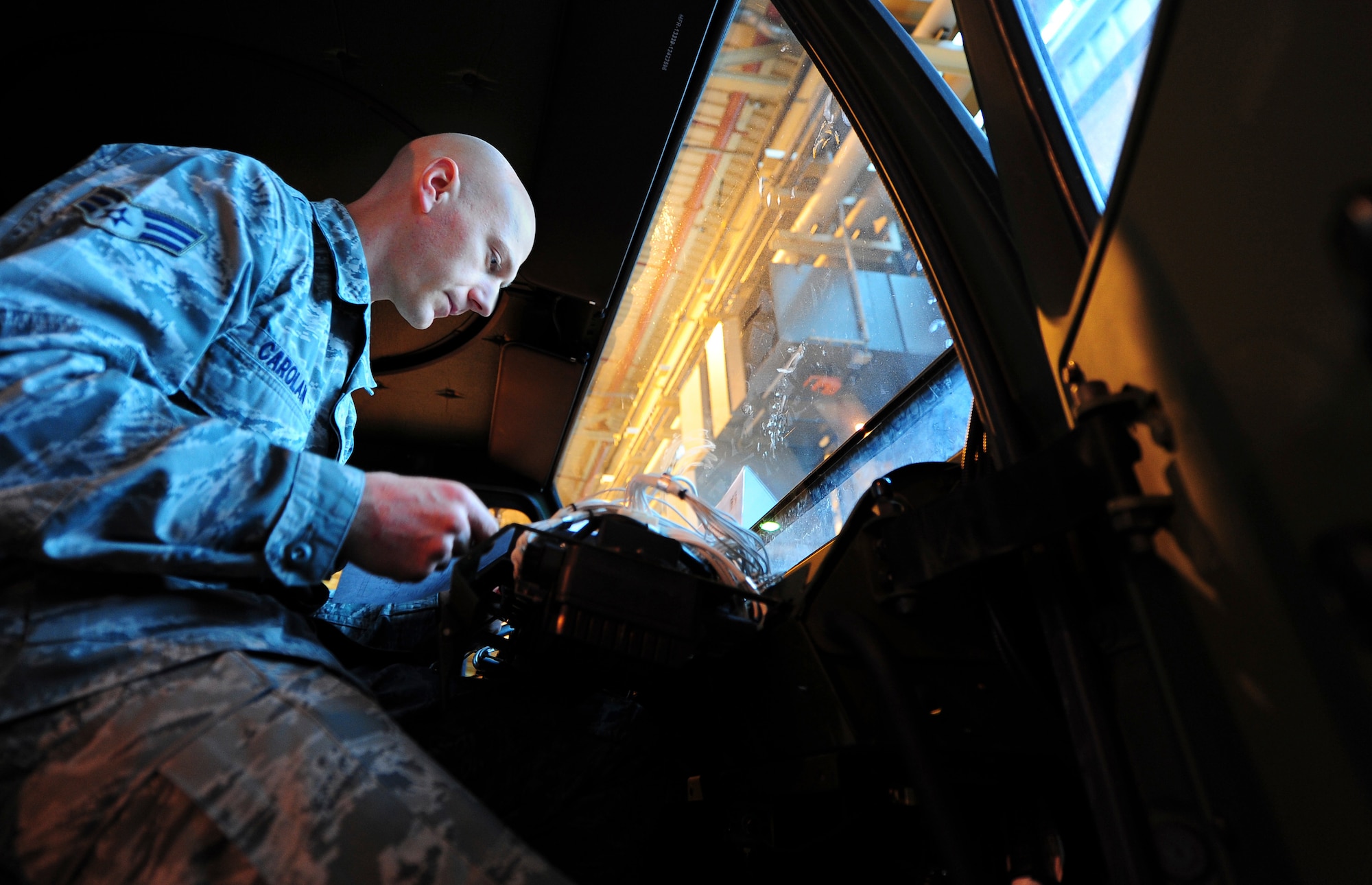 Senior Airman Nathan Carolan, 86th Vehicle Readiness Squadron vehicle maintenance apprentice, works on a wiring issue inside a 1078A1 light mobility terrain vehicle on Ramstein Air Base, Germany, Jan. 9, 2013. Carolan repaired the wiring to fix a no start condition. (U.S. Air Force photo/Airman 1st Class Jordan Castelan)
