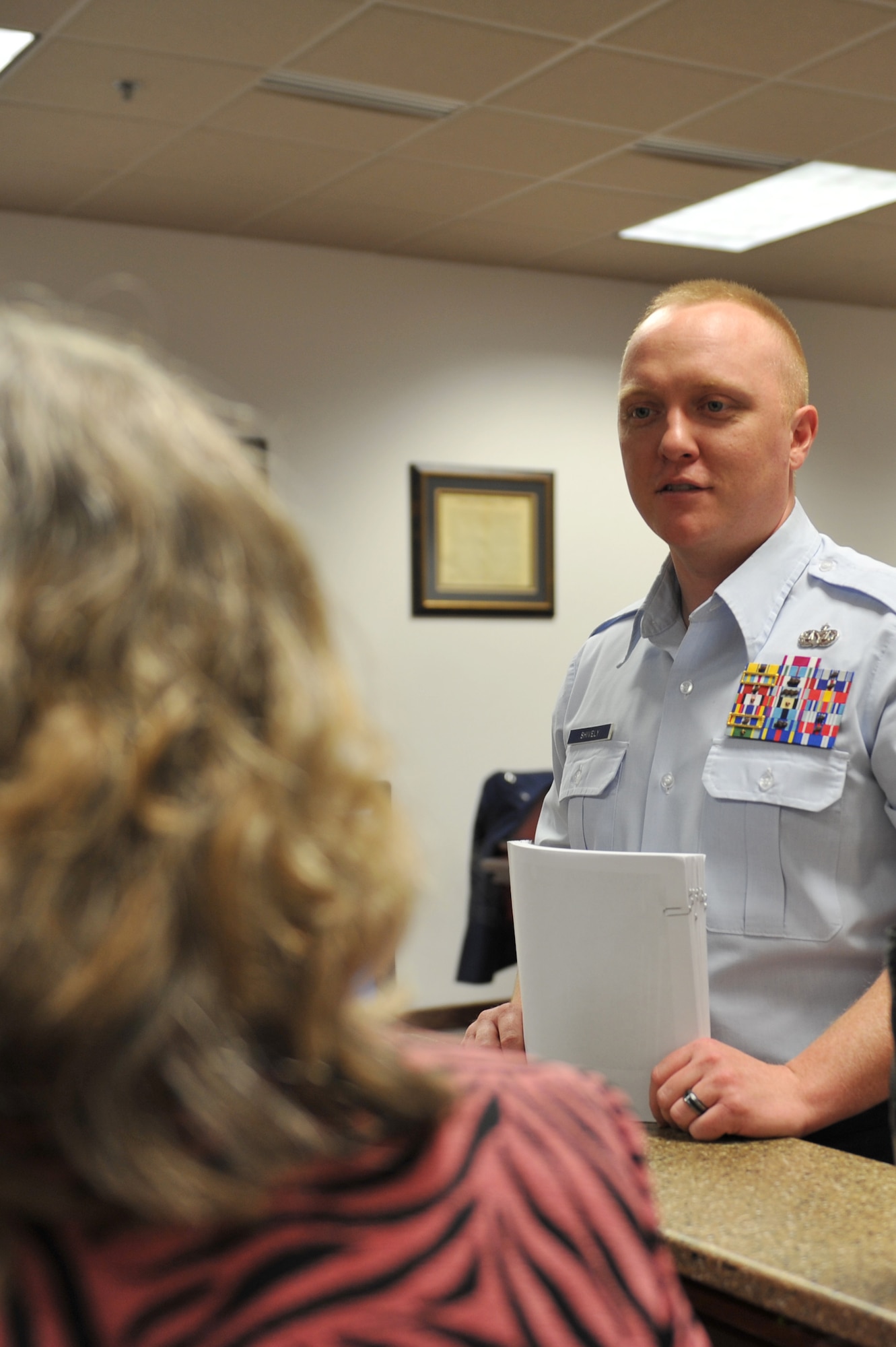 WHITEMAN AIR FORCE BASE, Mo. -- Tech. Sgt. Matthew Shively, 509th Bomb Wing Legal Military Justice NCO in charge, speaks with Barbara Lamb, 509th Bomb Wing court reporter, during shift at the 509th BW Legal Office, Feb. 12, 2013, at Whiteman Air Force Base, Mo. The team works with client concerns and trial preparation and is committed to ensuring customers’ needs are met. (U.S. Air Force photo/Heidi Hunt)