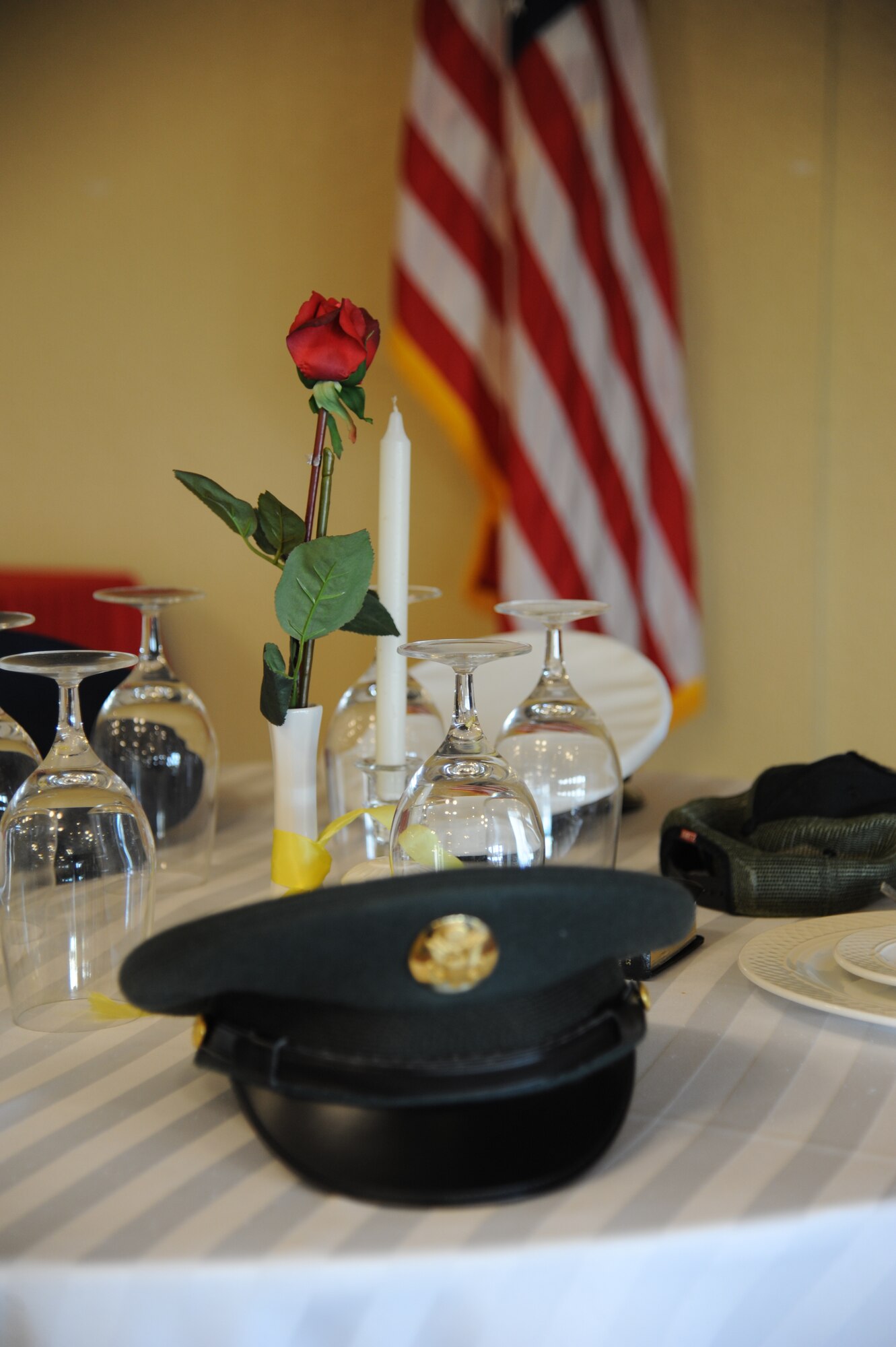 A ceremonial table to honor prisoners of war and those missing in action stands alone following a tribute by the Keesler Honor Guard at the National Prayer Luncheon Feb. 20, 2013, at the Bay Breeze Event Center, Keesler Air Force Base, Miss.  The event also included guest speaker, retired Col. Richard Toliver. The annual event, a tradition that stems back to President Dwight D. Eisenhower in 1953, allows individuals of different faiths and backgrounds to join together to reflect and develop their spiritual fitness. This year’s theme was “Pray for America.”  (U.S. Air Force photo by Kemberly Groue)