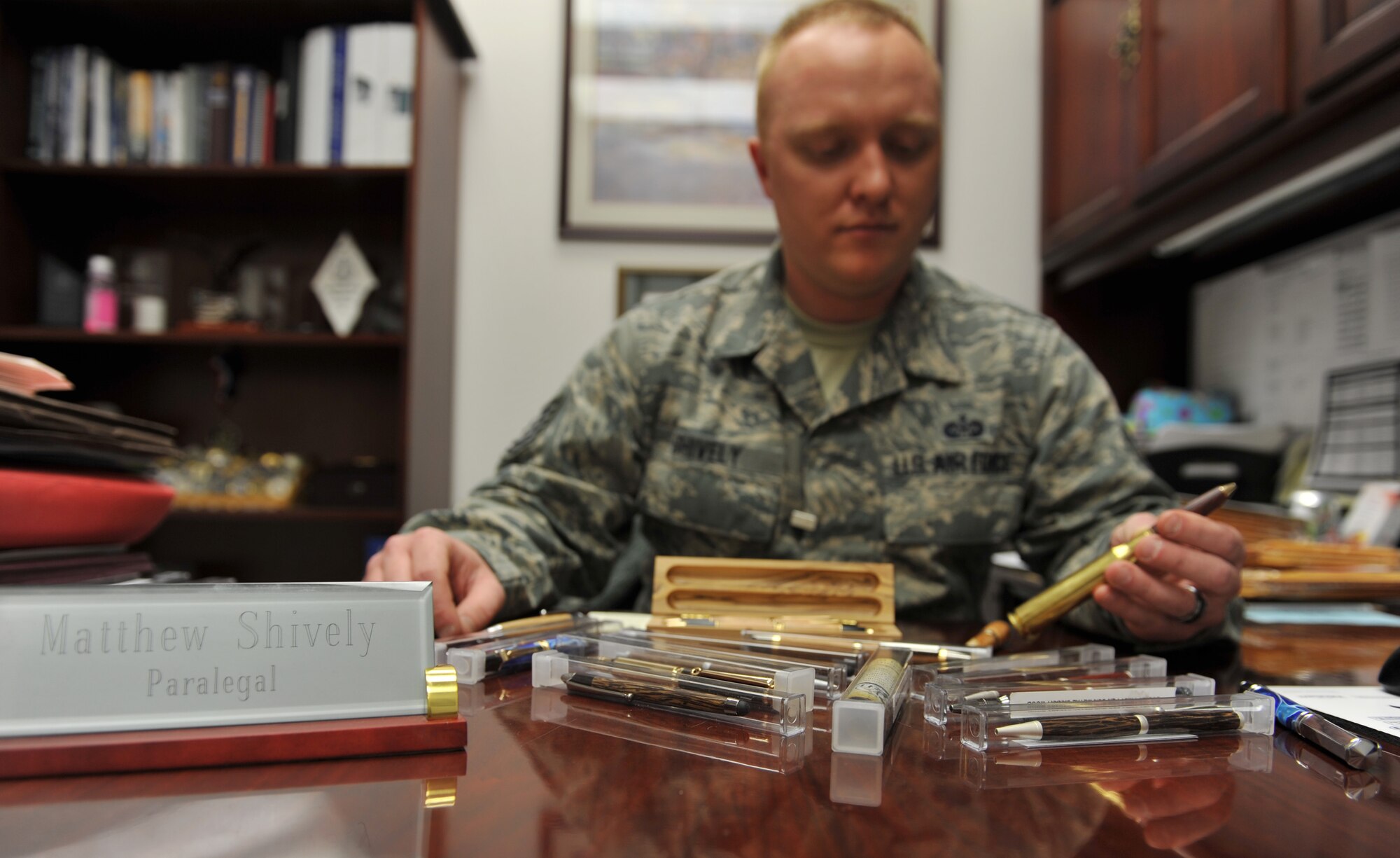 WHITEMAN AIR FORCE BASE, Mo. -- Tech. Sgt. Matthew Shively, 509th Bomb Wing Legal Military Justice NCO in charge, displays his writing pens that he makes as a hobby, Feb. 19, 2013. Shively sells the pens online and has sold 34 thus far. (U.S. Air Force photo/Heidi Hunt)