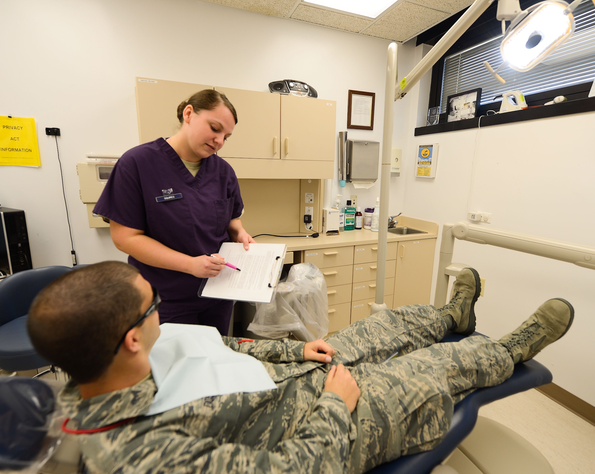 Air Mobility Command Annual Award winner Senior Airman Laura Squires reviews paperwork with a patient, Feb. 20, 2013. Squires is assigned to the 436th Dental Squadron, 436th Medical Group, Dover Air Force Base, Del. (U.S. Air Force photo/Greg L. Davis)