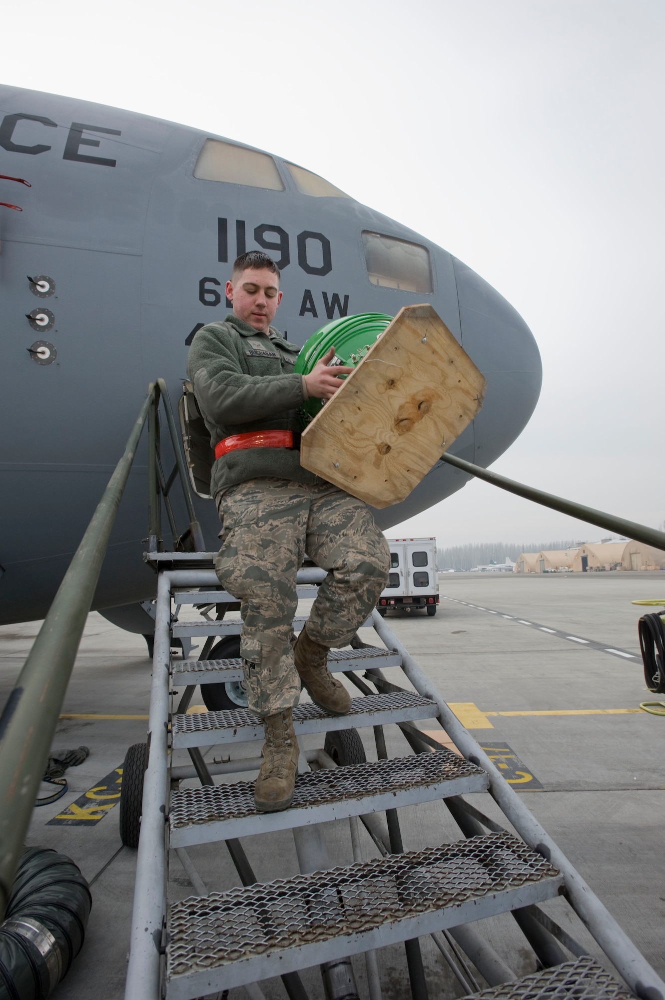 Airman 1st Class David Buchanan, 728th Air Mobility Squadron Operating Location-Alpha crew chief, carries a liquid oxygen converter removed from C-17 Globemaster III Feb. 21, 2013, at Transit Center at Manas, Kyrgyzstan. By performing routine maintenance and needed repairs, Airmen from the 728 AMS OL-A keep the C-17 ready to support airlift and onward movement. (U.S. Air Force photo/Staff Sgt. Stephanie Rubi)