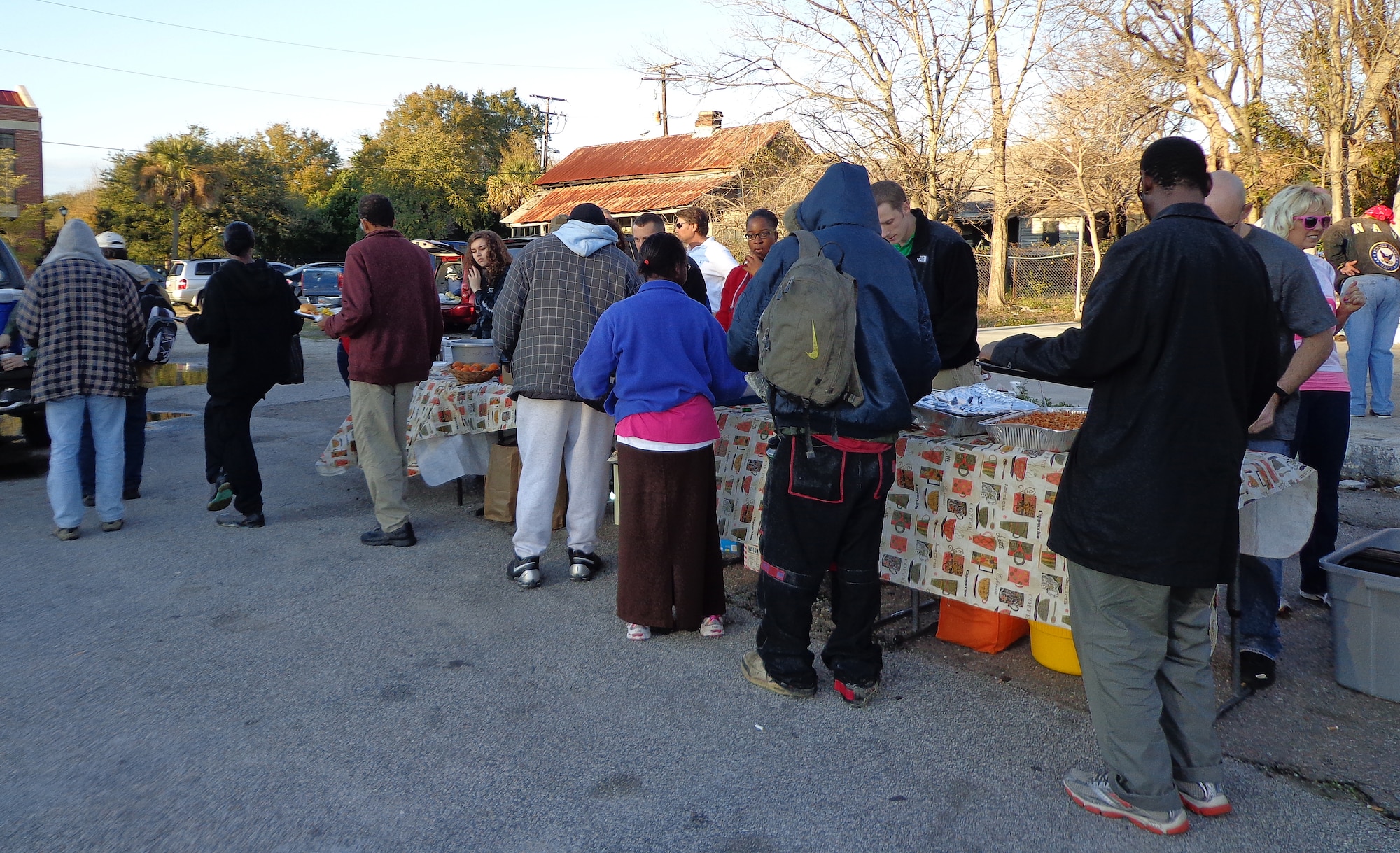 Members from the 17th Airlift Squadron volunteer their time as part of the Charleston Random Acts of Kindness Feb. 8, 2013, in downtown Charleston, S.C. The 17th AS has been supporting Charleston Random Acts of Kindness with the Feed a Friend Friday event for more than a year. Squadron members can be regularly seen serving on the food line when their flying schedules permit.  (Courtesy photo)