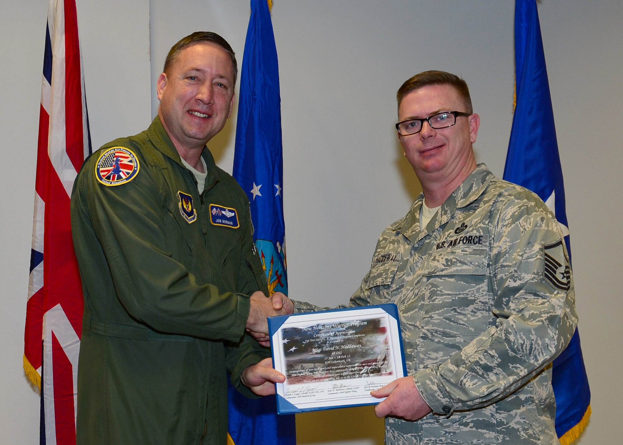 ROYAL AIR FORCE LAKENHEATH, England - Master Sgt. David Haddaway, 48th Operations Support Squadron NCOIC of intelligence target training, is presented with a New Horizons graduation certificate from Brig. Gen.  Jon Norman, Director to United States Air Forces in Europe-United Kingdom, Feb. 19, 2013. The New Horizons Wounded Warrior Support Program emphasizes physical, mental and spiritual support for wounded warriors stationed at RAFs Lakenheath, Mildenhall and Feltwell. (U.S. Air Force photo by Staff Sgt. Stephanie Mancha)