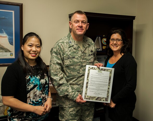 Colonel Richard McComb, Joint Base Charleston commander, presents the seventh annual Military Saves Campaign pledge to (left) Suerjee Lee, Joint Base Charleston – Weapons Station lead personal financial educator,  and Barbara  Lang, Community Readiness Consultant and Certified Financial counselor Feb. 13, 2013, at Joint Base Charleston – Air Base, S.C. Military Saves Week is Feb. 25 through March 2, 2013. (U.S. Air Force photo / Airman 1st Class Tom Brading)