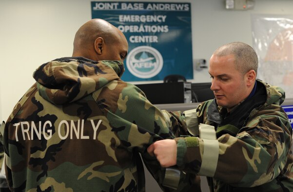 Airmen apply M9 Chemical Agent Detector tape to their into Mission Oriented Protective Posture (MOPP) gear during a Chemical, Biological, Radiological and Nuclear Defense (CBRN) Survival Skills Training course on Joint Base Andrews, Md., Feb. 14, 2013. The M9 is tape turns red indicating the presence nerve or blister agent. (U.S. Air Force photo/Airman 1st Class Nesha Humes)(Released)