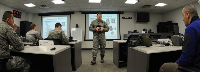 Staff Sgt. Eric Reist, 11th Civil Engineer Squadron emergency management training journeyman, instructs a Chemical, Biological, Radiological and Nuclear Survival Skills Training (CBRN SST) course on Joint Base Andrews, Md., Feb. 14, 2013. CBRN SST is taught to all members deploying to or changing station to a medium or high-threat area.  (U.S. Air Force photo/Airman 1st Class Nesha Humes)(Released)