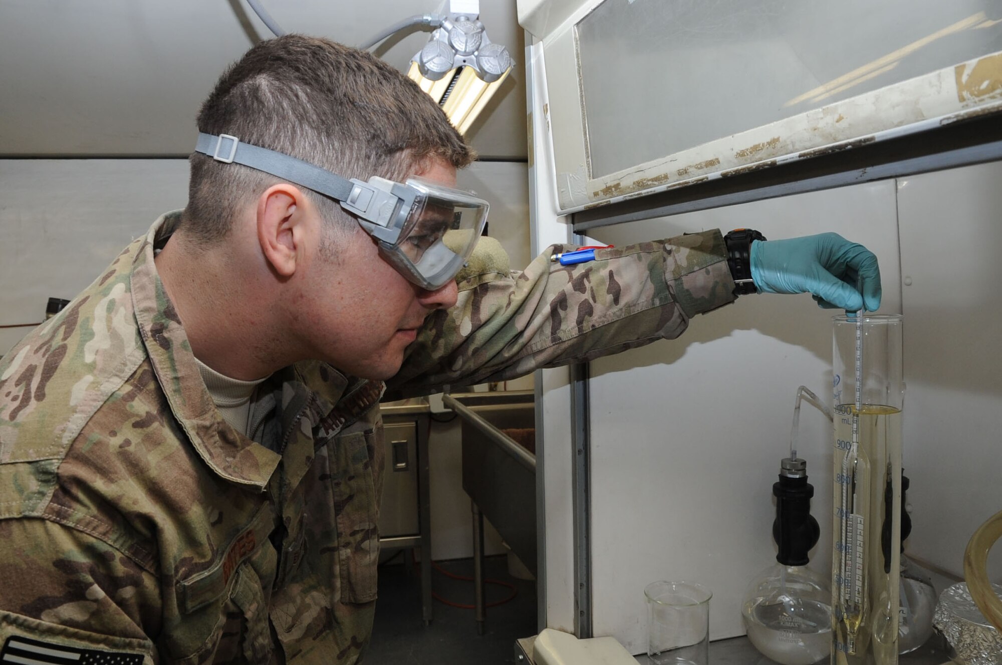 Staff Sgt. Chris Bates, 455th ELRS fuels laboratory NCO in charge, uses a hydrometer to test a sample of aircraft fuel on Bagram Airfield, Afghanistan, Feb. 21, 2013. This test is done every day to measure the net amount of fuel available, which can be affected by expansion or contraction due to weather conditions. (U.S. Air Force photo/Staff Sgt. David Dobrydney)