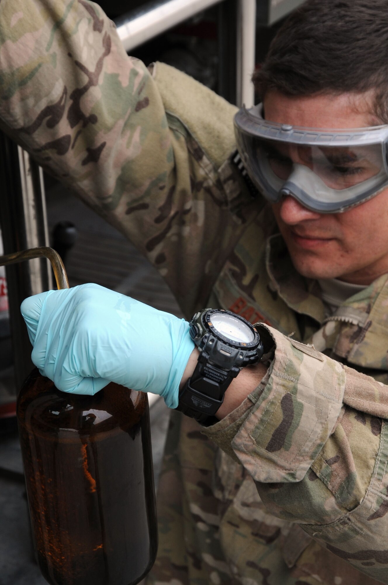 Staff Sgt. Chris Bates, 455th ELRS fuels laboratory NCO in charge, takes a fuel sample for testing on Bagram Airfield, Afghanistan, Feb. 21, 2013. The fuel must be tested daily for contraction or expansion due to the weather, which affects the net amount of fuel available for aircraft. (U.S. Air Force photo/Staff Sgt. David Dobrydney)
