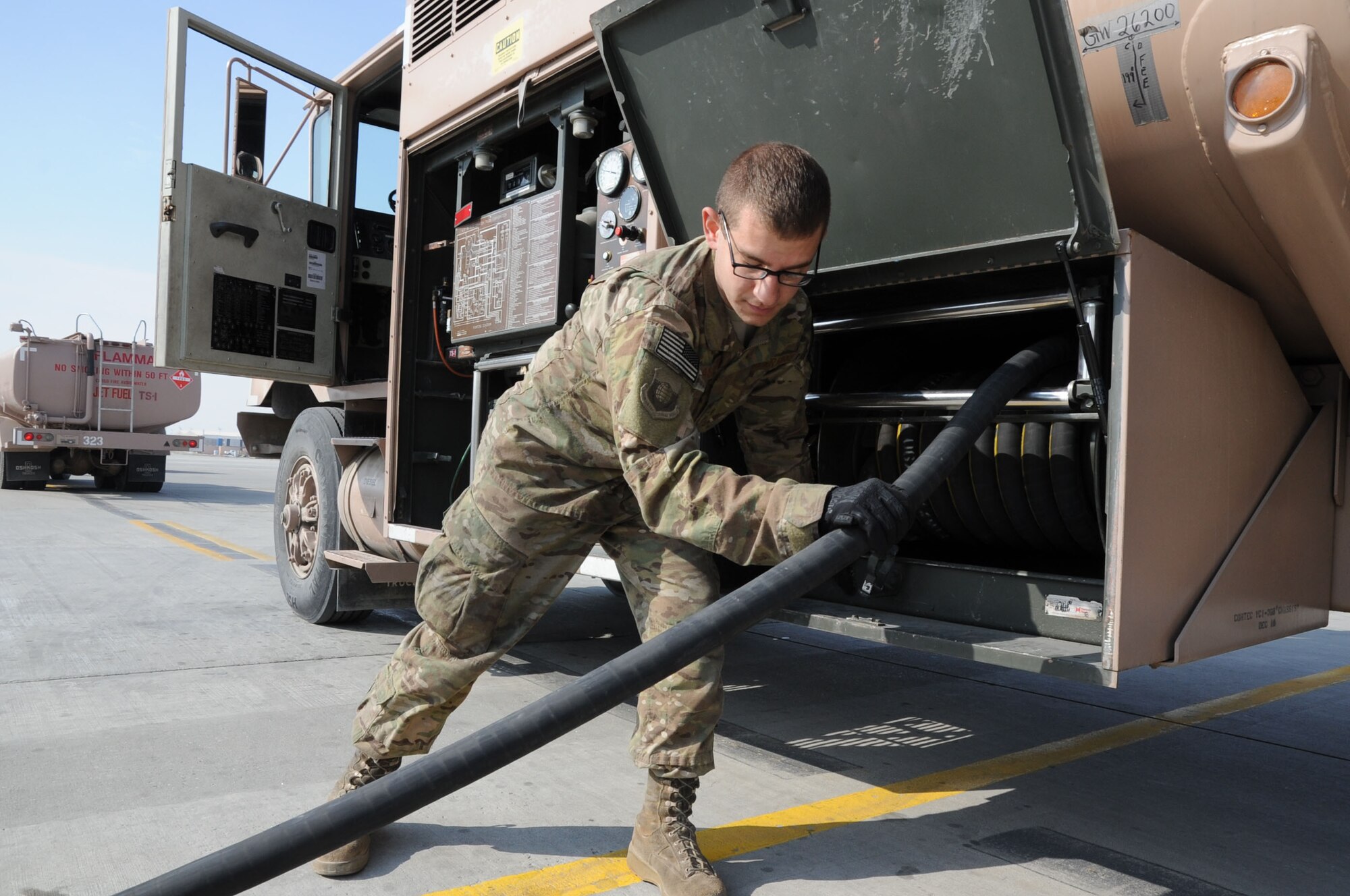 Airman 1st Class David Anastasio, 455th Expeditionary Logistics Readiness Squadron fuels systems distribution operator, rewinds a fuel hose on Bagram Airfield, Feb. 20, 2013. In his career as a Petroleum, Oil and Lubricant Airman, Anastasio has distributed two million gallons of fuel. (U.S. Air Force photo/Staff Sgt. David Dobrydney)