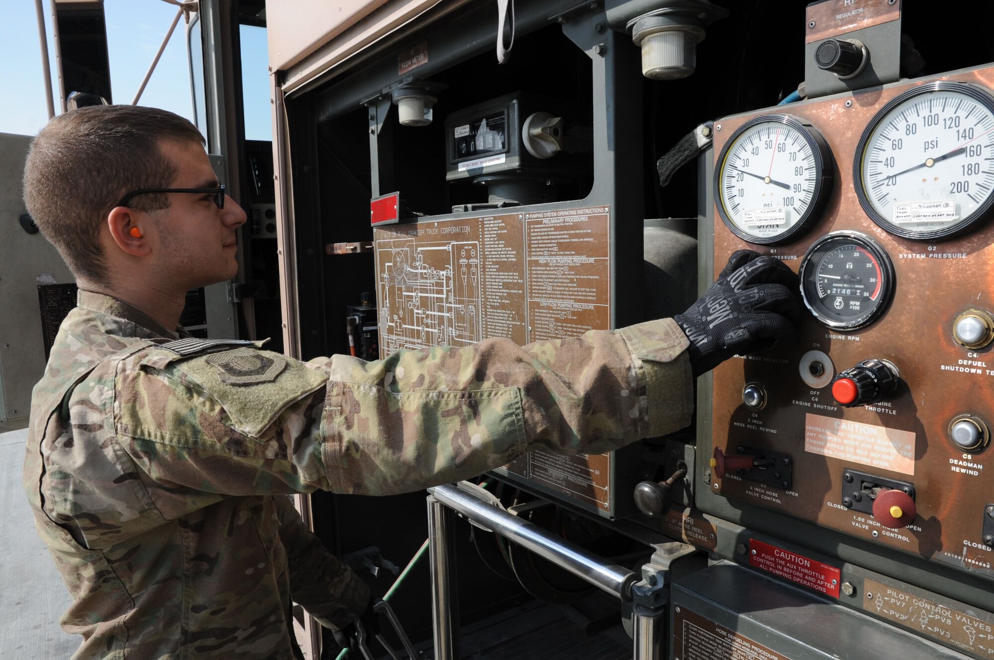Airman 1st Class David Anastasio, 455th Expeditionary Logistics Readiness Squadron fuels systems distribution operator, monitors the fuel being offloaded onto an aircraft on Bagram Airfield, Afghanistan, Feb. 20, 2013. The 455th ELRS Petroleum, Oil and Lubricants section refuels an average of 135 aircraft every day. (U.S. Air Force photo/Staff Sgt. David Dobrydney)
