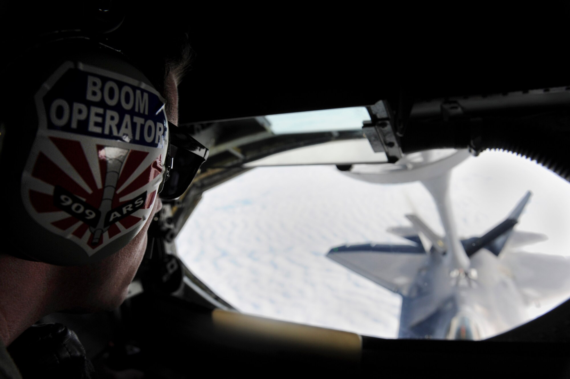 U.S. Air Force Airman 1st Class Matthew O’Daniel, 909th Air Refueling Squadron boom operator, refuels an F-22 Raptor fighter jet during a training sortie near Kadena Air Base, Japan, Feb. 19, 2013. Raptors from Joint Base Langley-Eustis, Va., are deployed to Kadena to demonstrate the continued U.S. commitment to fulfill security responsibilities throughout the Western Pacific and to maintain peace in the region. (U.S. Air Force photo/Airman 1st Class Malia Jenkins)