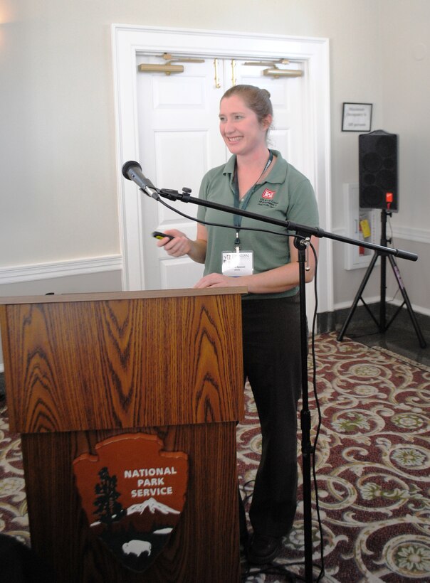 Jessica Spencer (left) of the Invasive Species Management Branch describes two new plants that have recently invaded Jacksonville, Fla. –Old World climbing fern and Saltcedar – at the 2013 Timucuan Science and History Symposium Jan. 25.    