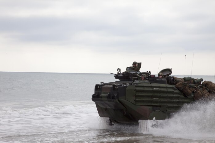 An amphibious assault vehicle carrying Marines and Sailors with Kilo Company, Battalion Landing Team (BLT) 3/2, 26th Marine Expeditionary Unit (MEU), arrives at Onslow Beach, Camp Lejeune, N.C., Feb. 16, 2013. The 26th MEU is conducting its Composite Training Unit Exercise, the final phase of a six-month pre-deployment training program. The 26th MEU operates continuously across the globe, providing the president and unified combatant commanders with a forward-deployed, sea-based quick reaction force. The MEU is a Marine Air-Ground Task Force capable of conducting amphibious operations, crisis response and limited contingency operations. (U.S. Marine Corps photo by Staff Sgt. Edward R. Guevara Jr./Released)